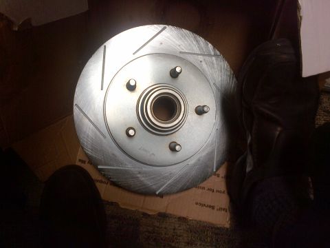 2003 Ford F-150 - A slotted brake rotor with a hub assembly is shown, likely a replacement part for a vehicle.