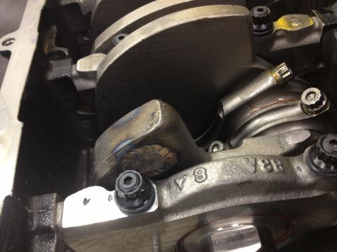 1992 Ford Crown Victoria - Close-up view of engine internals, including crankshaft and connecting rods, with visible V8 markings and weld repairs.