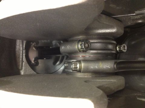 1992 Ford Crown Victoria - Close-up view of engine crankshaft and connecting rods, showing mechanical components and some markings.