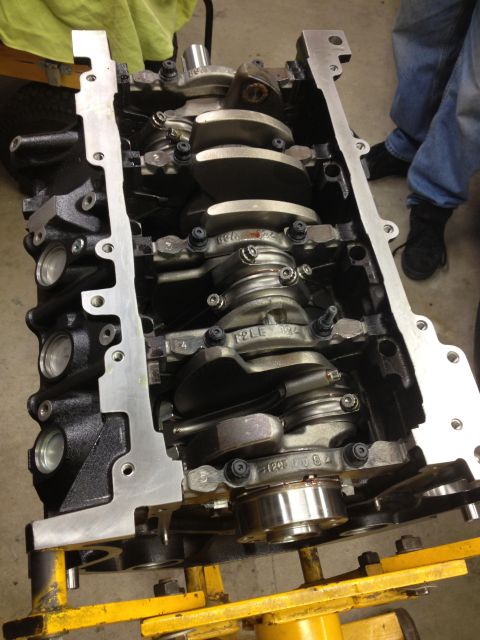 1992 Ford Crown Victoria - Engine block with crankshaft and connecting rods visible, mounted on a yellow stand.
