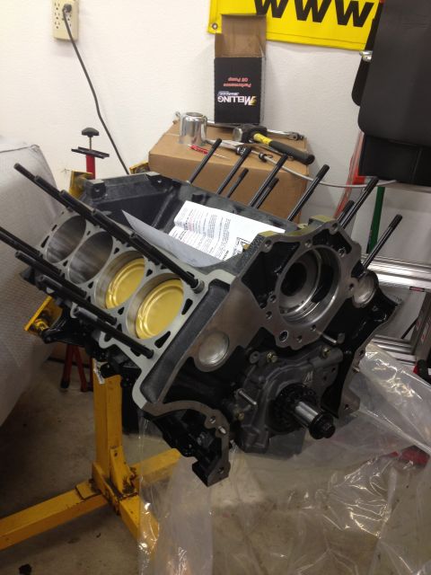 1992 Ford Crown Victoria - An engine block is disassembled and mounted on a stand, with tools and parts nearby.
