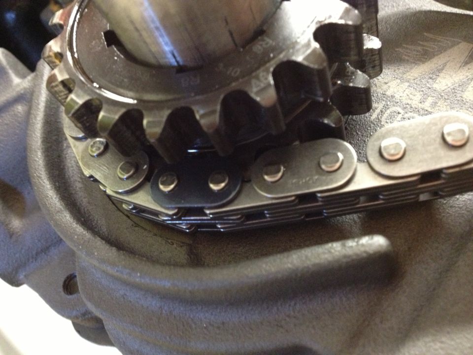 Engine timing chain and gear with visible text '3-10 R8 A6'