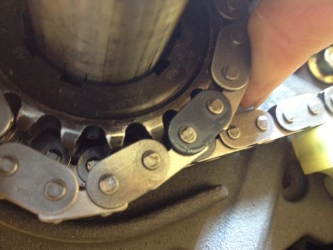 1992 Ford Crown Victoria - A timing chain is shown engaging with a gear, part of an engine assembly.