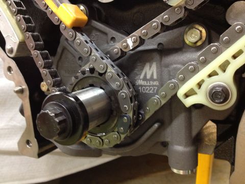 1992 Ford Crown Victoria - Close-up of engine timing components, including chains and sprockets, with visible manufacturer markings.