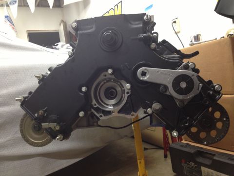 1992 Ford Crown Victoria - Engine timing cover assembly, likely for a Ford vehicle, is shown in a workshop setting.