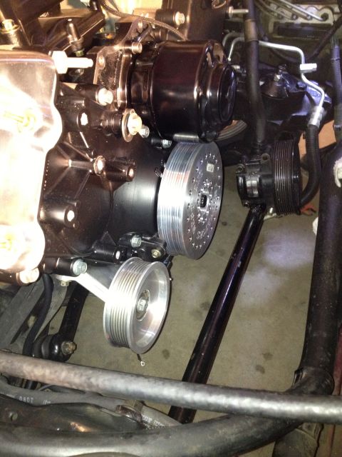 1992 Ford Crown Victoria - Close-up view of an engine motor assembly with multiple pulleys and belts.