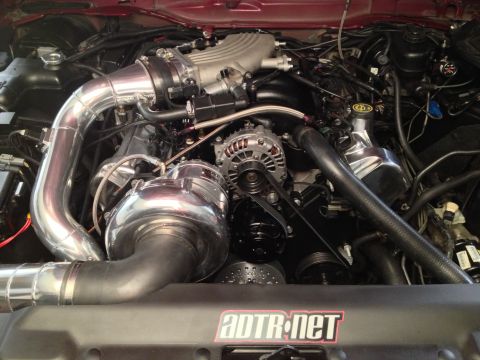 1992 Ford Crown Victoria - Custom engine bay with a prominent supercharger and polished components, suggesting performance modifications.
