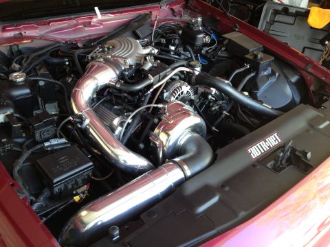 1992 Ford Crown Victoria - Custom supercharged engine bay with polished chrome components and red exterior paint.