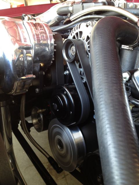 1992 Ford Crown Victoria - Close-up of a chrome supercharger and serpentine belt system on an engine.
