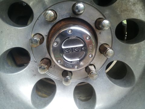 1988 Ford Bronco - Close-up of a vehicle's wheel hub, indicating its four-wheel-drive engagement settings.