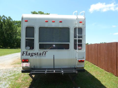 1992 Ford Mustang - This is the rear view of a Flagstaff camper by Forest River, a ladder and a bike rack.