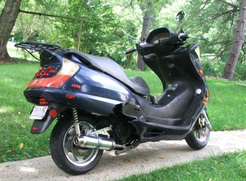 2008 Yamaha Zuma - This scooter appears to be a 2008 Yamaha Zuma, viewed from the rear.