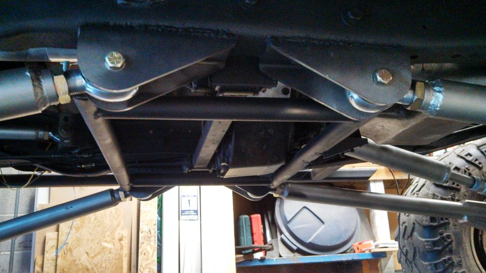 Undercarriage view of a custom suspension system with large shocks and linkages