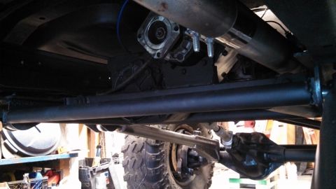 1967 Ford F-250 - Close-up view of the undercarriage components of a truck, including the transmission and rear axle.