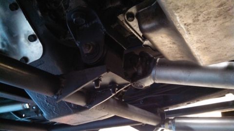 1967 Ford F-250 - The undercarriage of a truck, showing the driveshaft and suspension components.