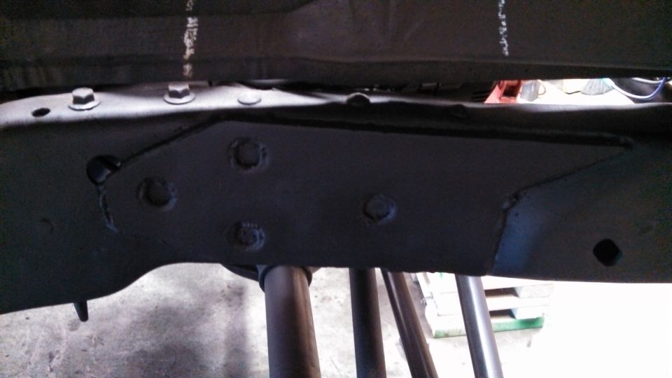Black painted truck frame section with visible bolts and brackets
