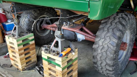 1967 Ford F-250 - Truck's rear axle and suspension are supported by jack stands during maintenance or modification.