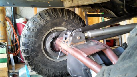 1967 Ford F-250 - Custom suspension parts and a large tire are visible on the underside of a vehicle.