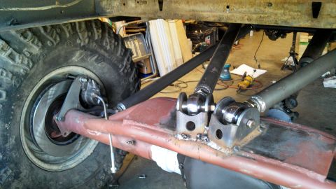 1967 Ford F-250 - Close-up view of a custom rear suspension setup, a large tire and disc brake components.