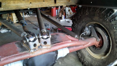 1967 Ford F-250 - Custom suspension linkage and axle assembly with a large off-road tire visible.