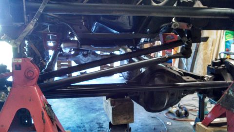 1967 Ford F-250 - The underside of a truck shows custom suspension and steering linkages, suggesting significant modifications.
