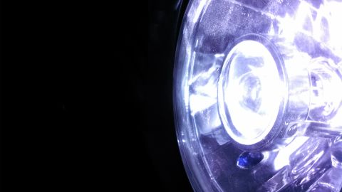 1967 Ford F-250 - Headlight lens detail against a black background.