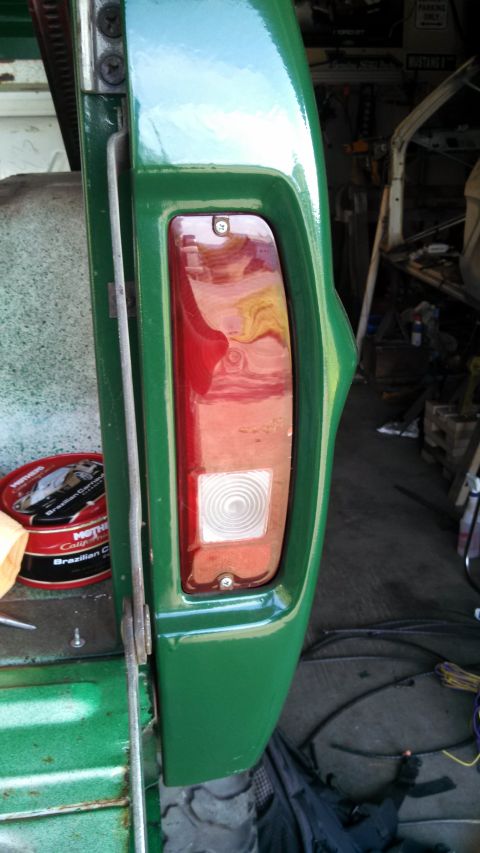 1967 Ford F-250 - Close-up of the rear tail light assembly on a green 1967 Ford F-250 truck.