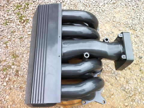 1992 Ford Bronco - This intake manifold has been painted gray and is shown outdoors on a gravel surface.