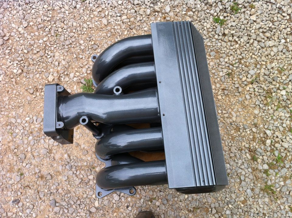 Gray intake manifold with four runners and a ribbed cover