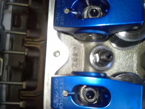 1992 Ford Bronco - Close-up of blue roller rocker arms installed on an engine block, showing the casting number X302.