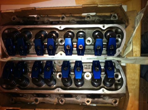 1992 Ford Bronco - Two engine cylinder heads, each with eight blue rocker arms, are shown in a cardboard box.