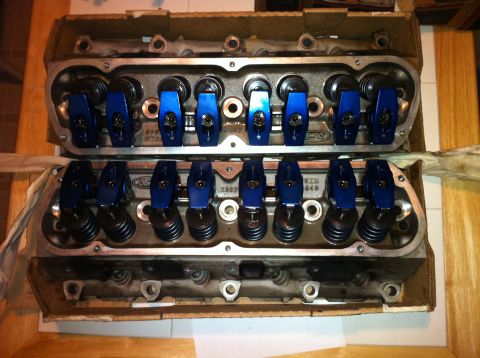 1992 Ford Bronco - Two Ford engine cylinder heads are shown, each with blue roller rocker arms installed.