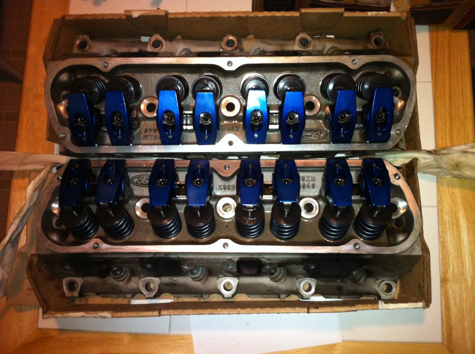 Pair of Ford engine cylinder heads with blue roller rockers