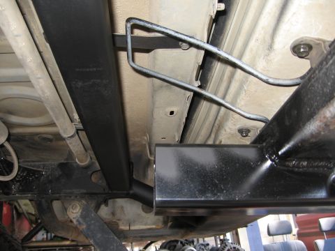 1993 Toyota 4Runner - Aftermarket rear bumper installation on a vehicle's underbody, showing frame and fuel lines.