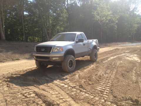 1996 Ford Bronco - This lifted Ford F-150 is equipped with large off-road tires for navigating rough terrain.