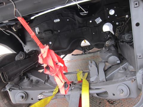 1991 Ford LTD Crown Victoria - The engine bay of a 1991 Ford Crown Victoria LTD is visible, secured with red and yellow straps.