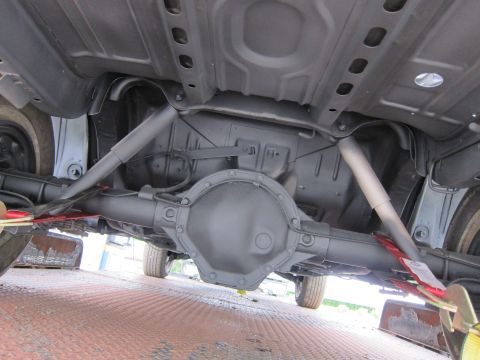 1991 Ford LTD Crown Victoria - The undercarriage of a vehicle, showing the rear differential and suspension system.