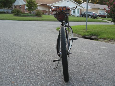 1994 Ford Bronco - Customized bicycle with a unique taillight and license plate is parked on a residential street.