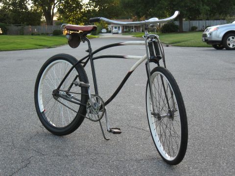 1994 Ford Bronco - A custom cruiser bicycle with a distinctive frame design is shown outdoors on an asphalt road.