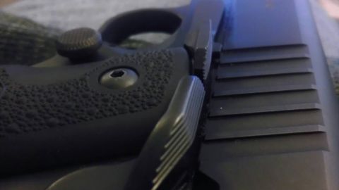 2000 Mercury Grand Marquis - A detailed view of a firearm's grip and slide, showing textured surfaces and slide serrations.