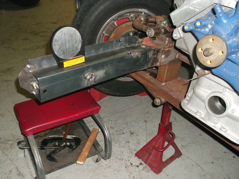 1964 Ford Fairlane - A close-up view of vehicle frame components and engine parts, with a leveling gauge attached.