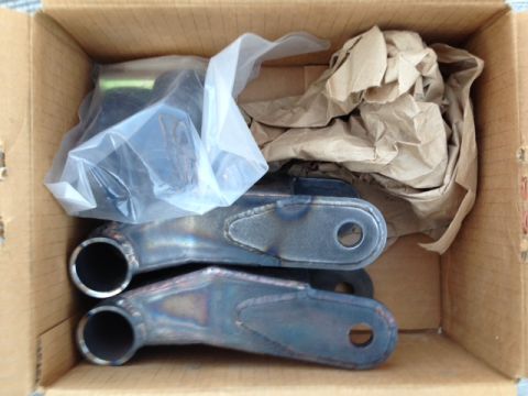 1986 Ford Bronco - Unboxed suspension parts, possibly for a vehicle lift or modification.