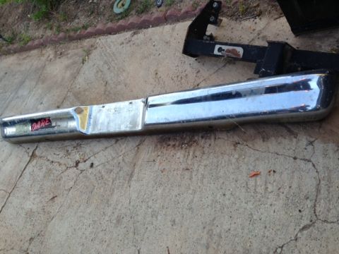 1986 Ford Bronco - A chrome bumper with a red "DARE" sticker is shown, attached to a black bracket.