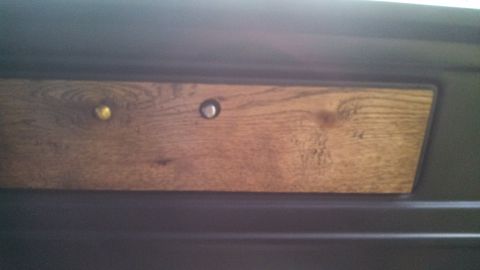 1979 Ford Bronco - Close-up of a wood grain trim panel two knobs, one gold and one silver.