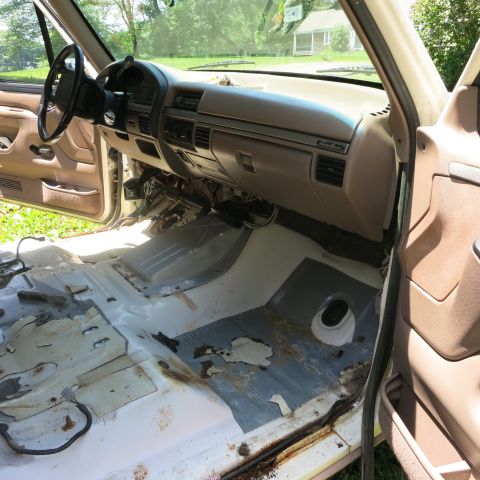 1995 Ford Bronco - Interior view of a 1995 Ford Bronco showing the stripped-down floor and dashboard.