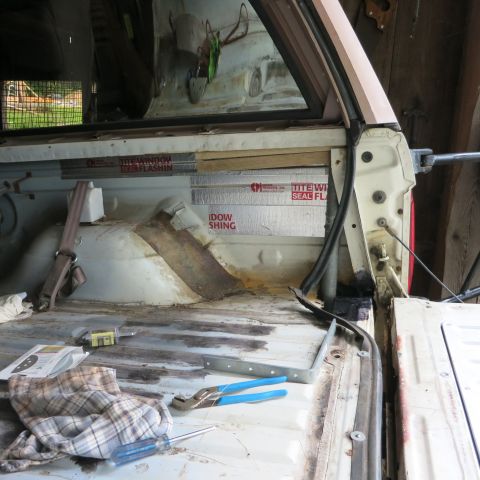 1995 Ford Bronco - Tools and insulation are laid out inside a vehicle undergoing interior work.