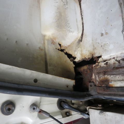 1995 Ford Bronco - Significant corrosion is visible on the vehicle's frame, indicating structural compromise.