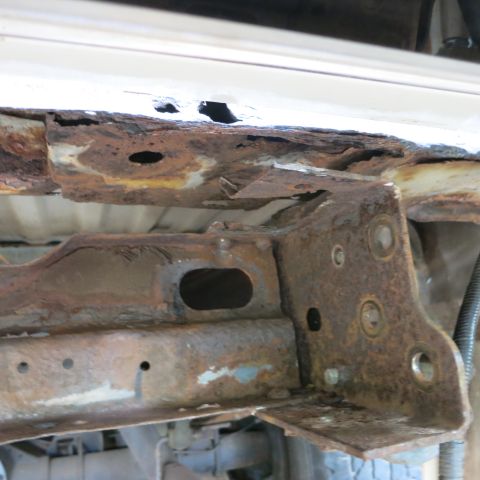 1995 Ford Bronco - The vehicle frame shows extensive rust and structural damage, indicating a poor condition.
