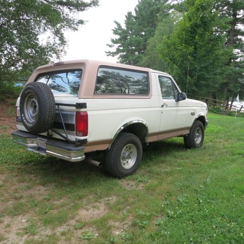 1995 Ford Bronco - This 1992 Ford Bronco is shown from a three-quarter rear view, parked outdoors on a grassy area.
