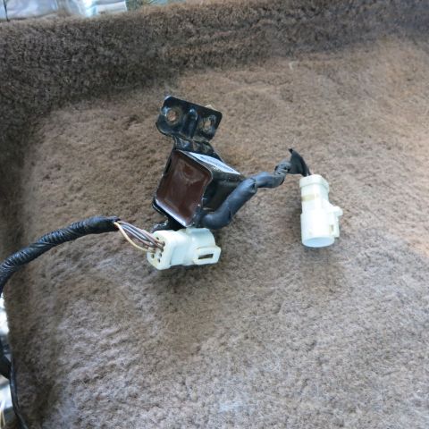 1995 Ford Bronco - A close-up view of a vehicle's wiring harness and an associated electronic component, likely part of the interior trim.